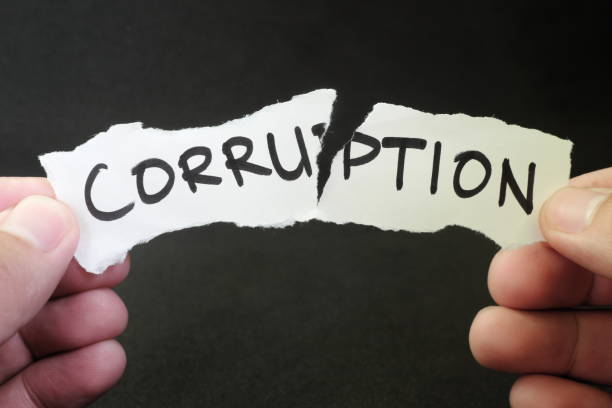 Stop and fight corruption concept. Human hand tearing a piece paper with written word corruption. Stop and fight corruption concept. Human hand tearing a piece paper with written word corruption. corruption stock pictures, royalty-free photos & images
