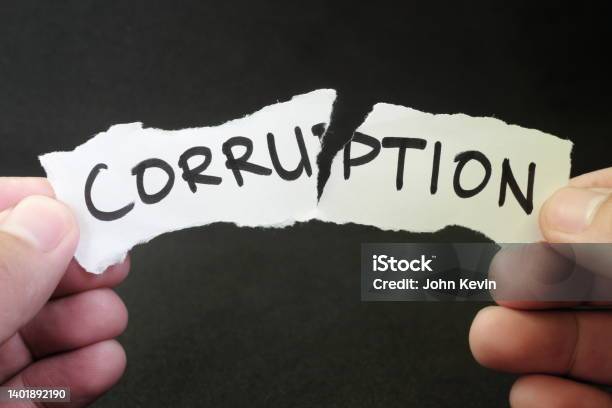 Stop And Fight Corruption Concept Human Hand Tearing A Piece Paper With Written Word Corruption Stock Photo - Download Image Now