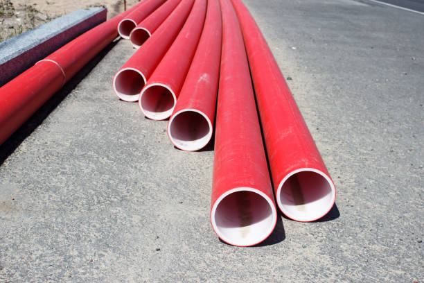 istock red plastic pipes lying on the road 1401892396