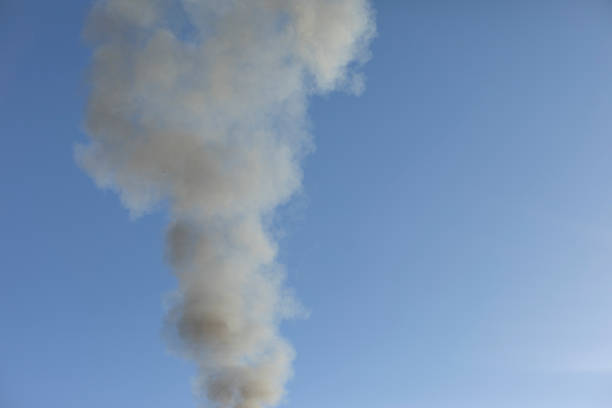 istock Smoke and sky. Black smoke billows in air. 1401892890