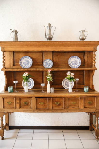 istock Old wooden cupboard served with flowers and plates 1401894818