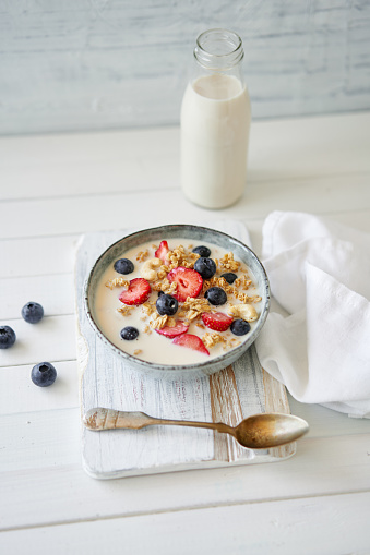 Granola with yogurt, strawberries and oat milk