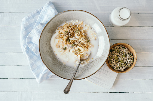 Nut granola with coconut drink, pumpkin seeds and toasted coconut