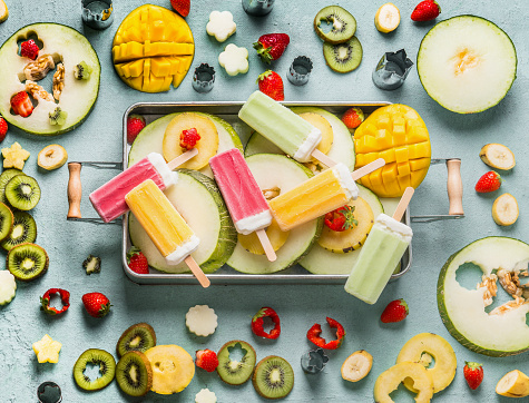 Various colorful popsicle ice cream, fresh fruits and berries in tray , top view. Summer food . Horizontal