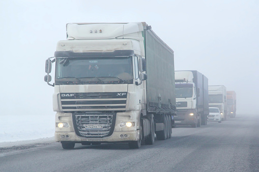 Bashkortostan, Russia - February 7, 2016: Semitrailer truck DAF XF at an intercity road during a heavy fog.