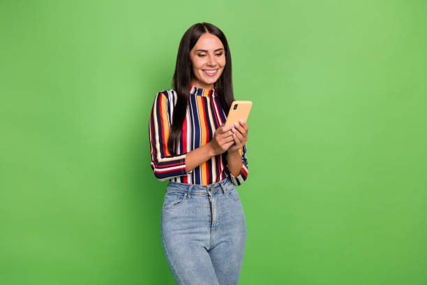 istock Portrait of attractive focused cheerful girl using device gadget browsing web 5g isolated over green pastel color background 1401895874