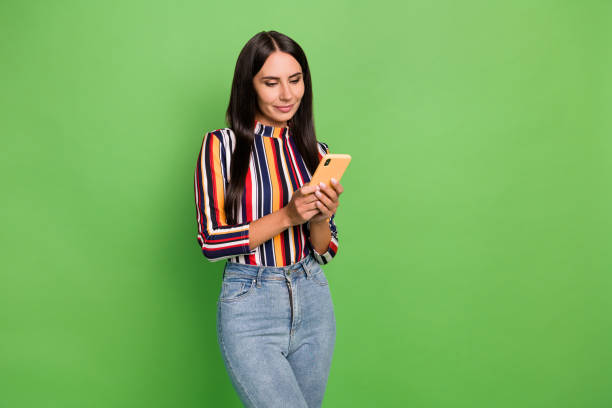 istock Portrait of attractive focused girl using device gadget app 5g browsing isolated over bright green color background 1401896515