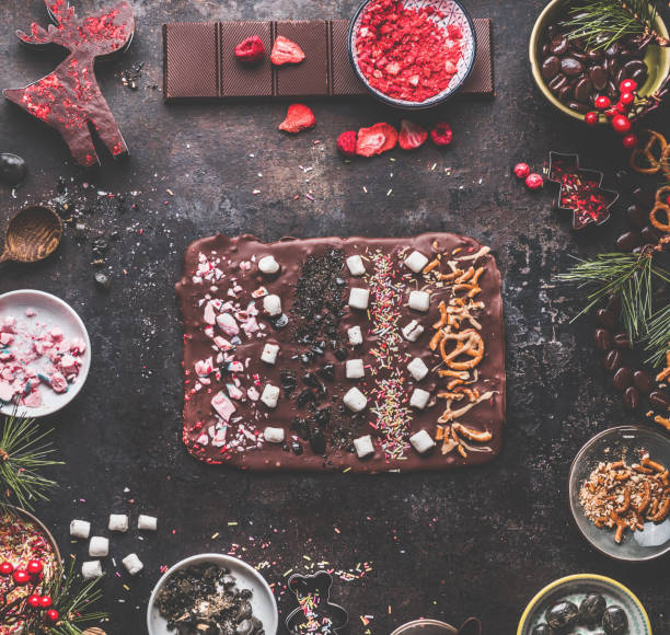 istock Christmas chocolate bark with various topping. Sweet candy gift preparation with ingredients. 1401897131