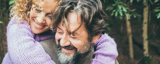 istock Smiling Couple Embracing In Forest 1401899176