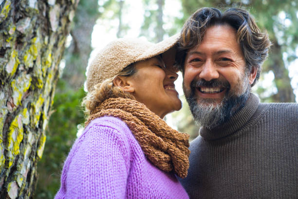 istock Smiling Couple Embracing In Forest 1401899198