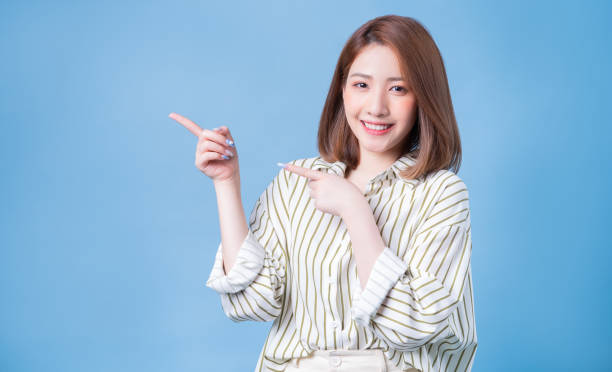 istock Image of young Asian girl posing on blue background 1401899416