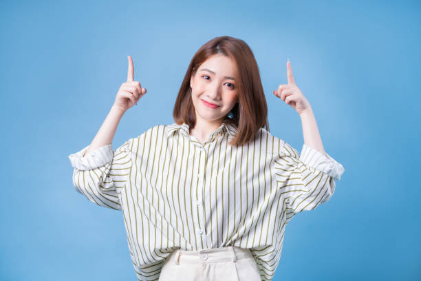 istock Image of young Asian girl posing on blue background 1401899419