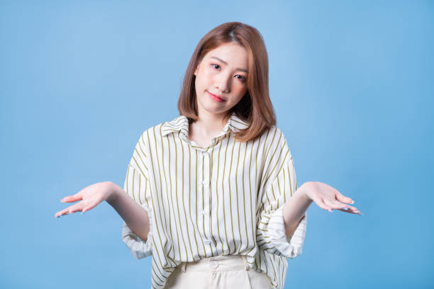 istock Image of young Asian girl posing on blue background 1401899440