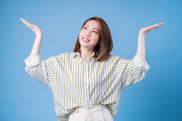 istock Image of young Asian girl posing on blue background 1401899444