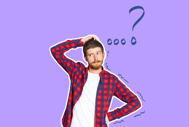 istock Young thoughtful guy has doubts, standing on purple background. Concept of human emotions, facial expression, youth, education, business, ad. 1401899735