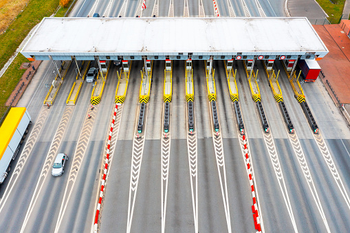 View from a height of the checkpoint. Cars pass through an automatic toll booth on a toll road in Europe. Poland
