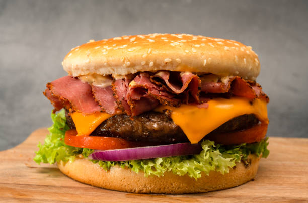istock Delicious cheeseburger with tomatoes, onion, lettuce, pastrami and cheese 1401904603
