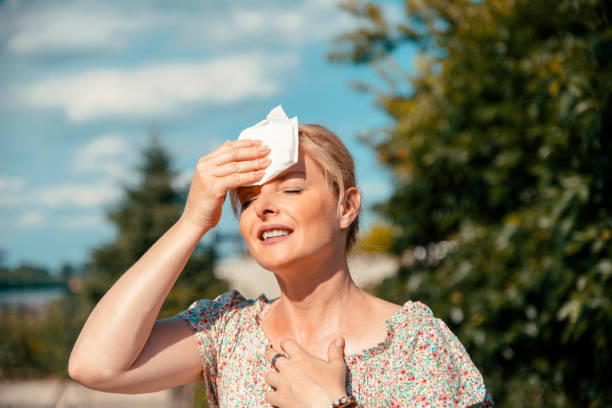 istock Woman having hot flashes and sweats 1401907666