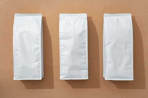 White blank matte coffee package on paper background, copy space