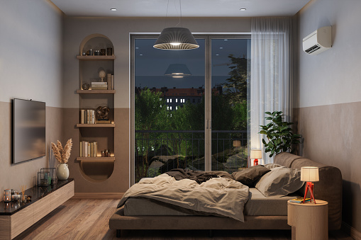 Modern Bedroom Interior At Night With Messy Double Bed, Air Conditioner And Television Set