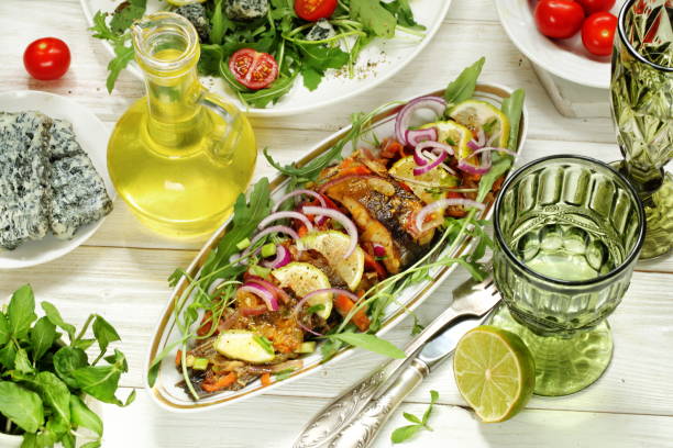 istock Salad with arugula and a dish of fried carp 1401911789