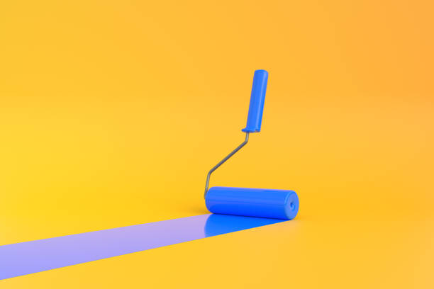 istock Blue Paint Roller with color trail over yellow background 1401915376