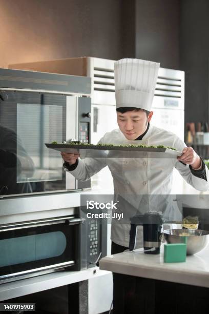 Male Chinese Pastry Chef Smelling Matcha Cookies Before Baking Them In The Oven Stock Photo Stock Photo - Download Image Now