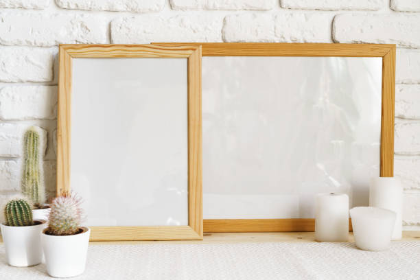 istock Square wooden photo frame and cactus plants on the table 1401917139