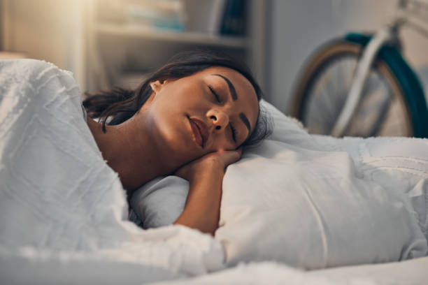 istock A beautiful young mixed race woman sleeping in a soft comfortable bed at home. One hispanic female feeling exhausted and resting in a comforting bed 1401917258