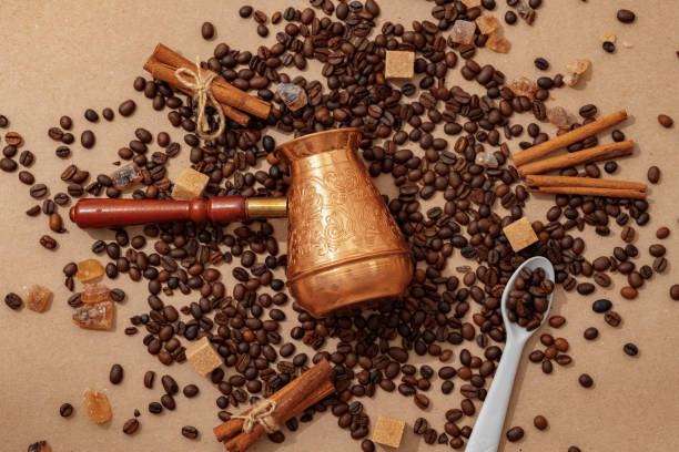 istock Coffee pot with coffee beans on paper background 1401917534
