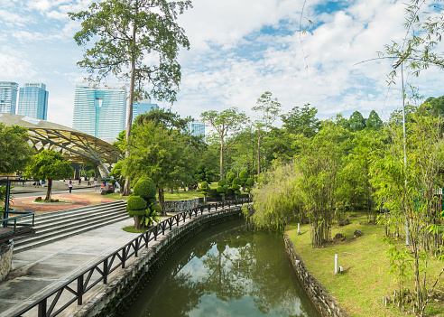 Kuala Lumpur, Malaysia - May 29,2022 : Landscape morning view of the Kuala Lumpur Perdana Botanical Gardens, it is KL's first large-scale recreational park. People can seen exploring around it.