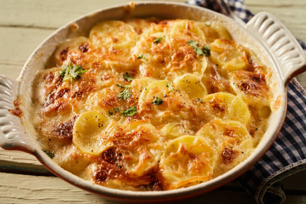 istock Scalloped potatoes in ceramic baking dish on towel 1401921618