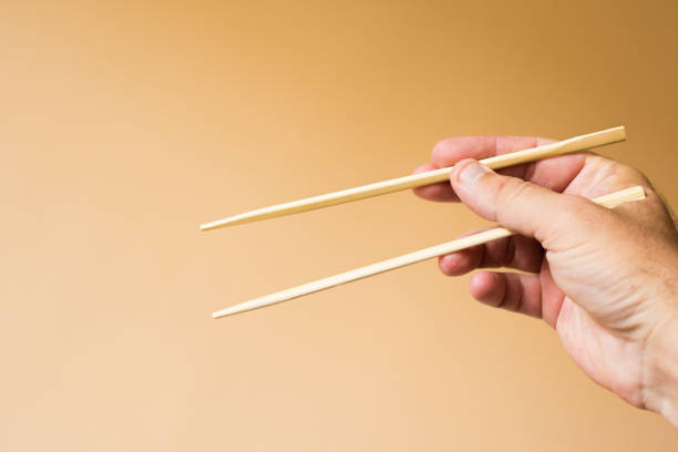 istock chinese chopsticks in hand 1401922841