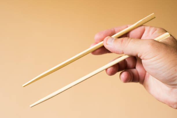 istock chinese chopsticks in hand 1401922843