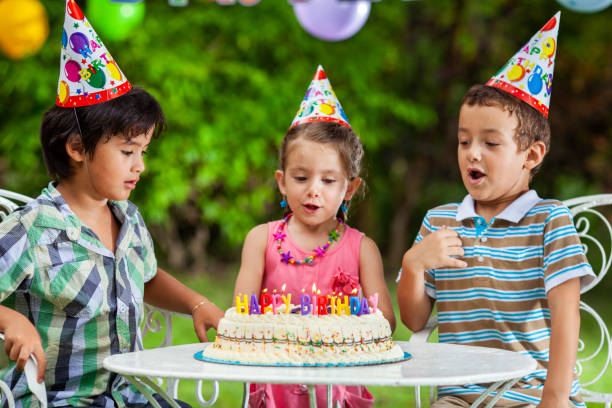 istock Children blowing Birthday candles 1401922856