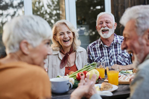 istock Cheerful mature friends talking during breakfast on a terrace. 1401924294