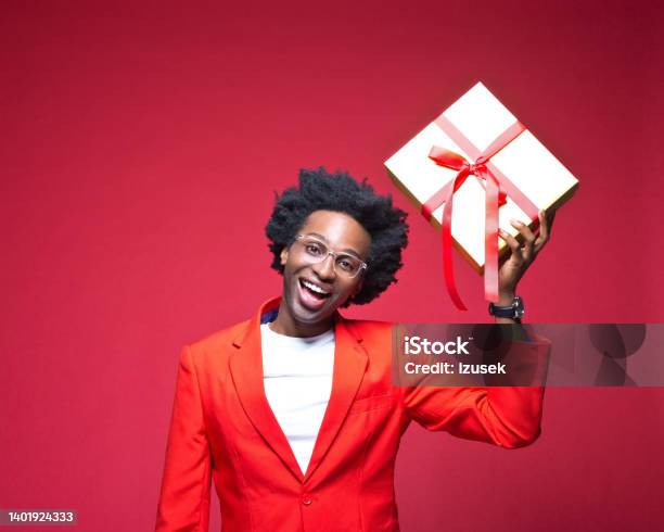 Businessman Laughing While Holding Gift Box Stock Photo - Download Image Now - Gift Box, Men, Studio Shot