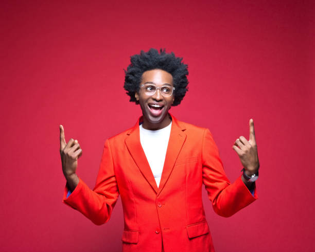 istock Businessman pointing fingers against red background 1401924441