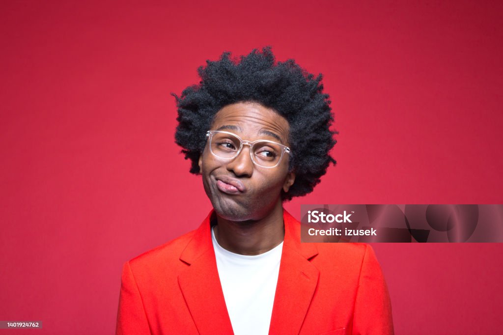 Businessman with eyeglasses making face Businessman in red blazer with facial expression against colored background Men Stock Photo