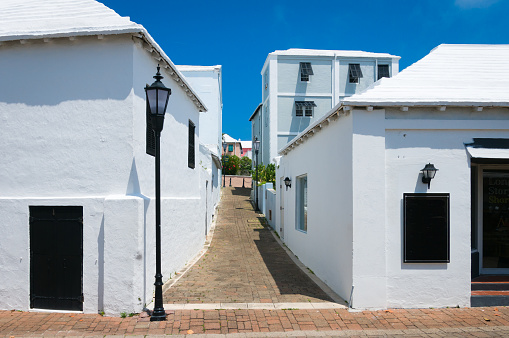 A narrow alley between whitewashed stucco buildings in St. George, Bermuda