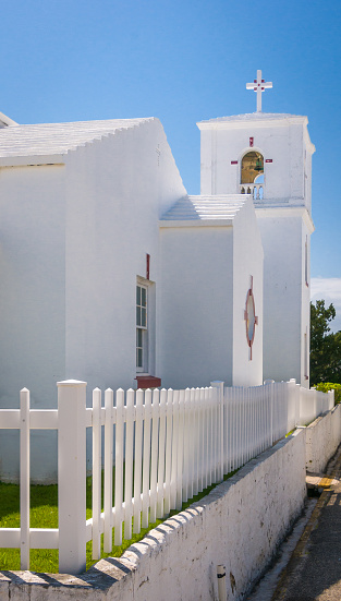The Stella Maris church and bell tower surrounded by a white picket fence in St. George, Bermuda