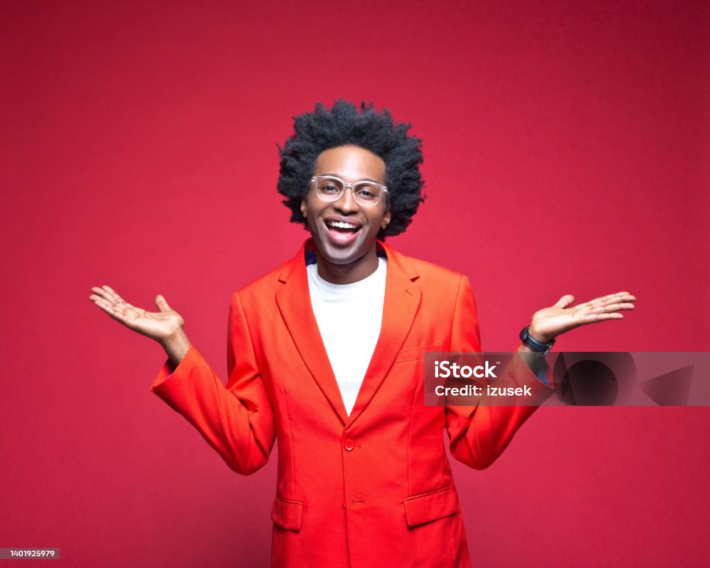 Happy businessman gesturing Portrait of cheerful businessman in red blazer gesturing while standing against colored background Confidence Stock Photo