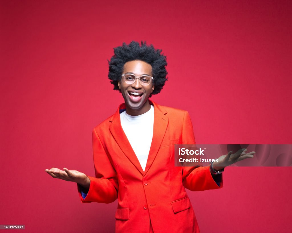 Happy businessman gesturing against red background Portrait of happy businessman in red blazer gesturing standing against colored background Businessman Stock Photo