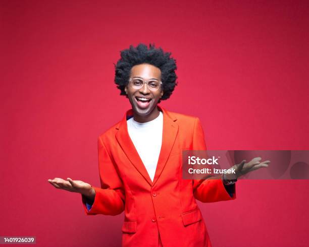 Happy Businessman Gesturing Against Red Background Stock Photo - Download Image Now - Businessman, Excitement, Handsome People