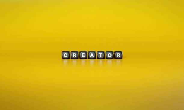 istock Word ‘Creator’ spelled out in white text on dark wooden blocks against plain yellow background. 3D rendering 1401927749