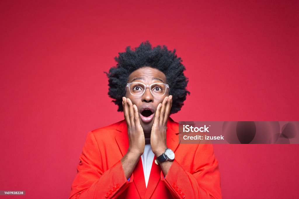 Man with hand on chin Shocked businessman with hand on chin wearing blazer against red background 30-34 Years Stock Photo
