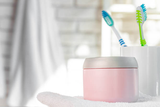 istock Cosmetic bottles against white bathroom wall background 1401931378