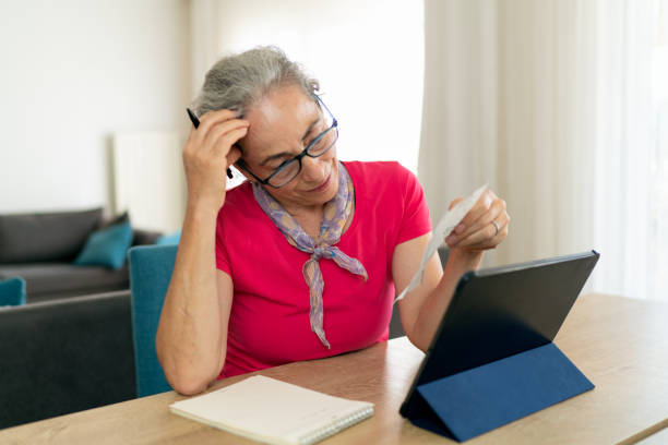 istock Senior woman calculating expenses 1401931552