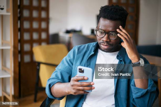 Reading About Bad News Using A Smart Phone Stock Photo - Download Image Now - Using Phone, Anger, One Person