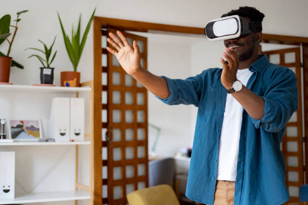 istock Male gamer using virtual reality googles at home 1401932496
